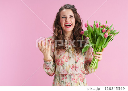 smiling young woman with long wavy brunette hair on pink smiling young woman with long wavy brunette hair on pink 110845549