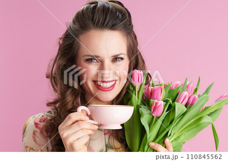 smiling stylish woman with long wavy brunette hair on pink smiling stylish woman with long wavy brunette hair on pink 110845562