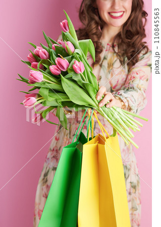 Closeup on smiling woman in floral dress on pink Closeup on smiling woman in floral dress on pink 110845563
