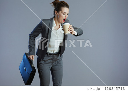 shocked elegant woman worker running isolated on gray shocked elegant woman worker running isolated on gray 110845718