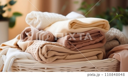 Basket with washed linen and towels. Concept of purity and freshness. Household duties, housework. 110848048