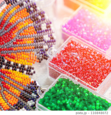 Colorful glass beads. Variety of shapes and colors to make a bead necklace or a string of beads for women Colorful glass beads. Variety of shapes and colors to make a bead necklace or a string of beads for women 110848072