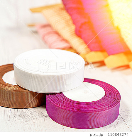 Colored ribbons and lace in coils for hobbies Colored ribbons and lace in coils for hobbies 110848274