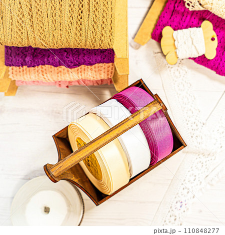 Colored ribbons and lace in coils for hobbies Colored ribbons and lace in coils for hobbies 110848277