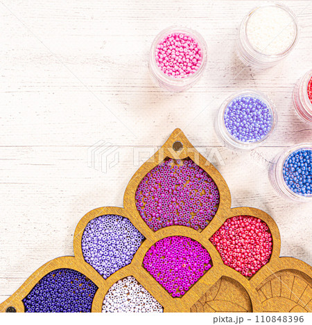 Colorful glass beads. Variety of shapes and colors to make a bead necklace or a string of beads for women 110848396