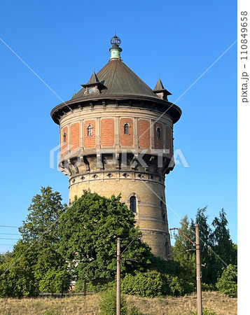 Vertical shot of an old water tower in Riga, Latvia against clear blue sky. Vertical shot of an old water tower in Riga, Latvia against clear blue sky. 110849658