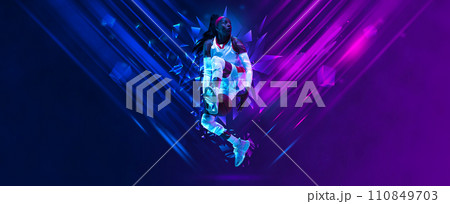 African young woman, basketball player in motion, jumping with ball on gradient background with polygonal and fluid neon elements. African young woman, basketball player in motion, jumping with ball on gradient background with polygonal and fluid neon elements. 110849703