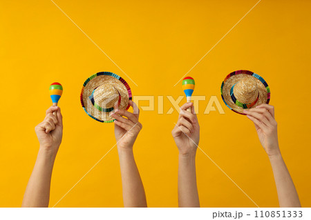 Mexican symbols in the hands of women. 110851333