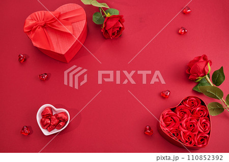 Gift box with beautiful red ribbon and roses, concept of Valentine's, anniversary, mother's day Gift box with beautiful red ribbon and roses, concept of Valentine's, anniversary, mother's day 110852392