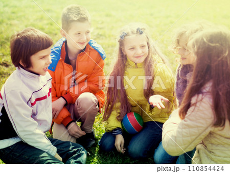 Group of children in park in spring 110854424