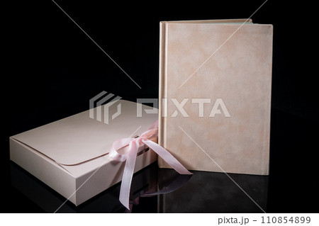 Best gift for men. Man gift concept. Pink notebook with Pink gift box on black background. Copy space text. Valentine's day, wedding, birthday and special occasion gift concept. Copy space for text. Best gift for men. Man gift concept. Pink notebook with Pink gift box on black background. Copy space text. Valentine's day, wedding, birthday and special occasion gift concept. Copy space for text. 110854899