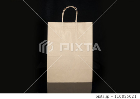 Recyclable craft paper bag for purchases, gifts and takeaway food mock up on black background. Environmentally friendly than single-use plastic bags Recyclable craft paper bag for purchases, gifts and takeaway food mock up on black background. Environmentally friendly than single-use plastic bags 110855021