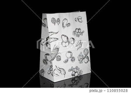 Recyclable craft paper bag for purchases, gifts and takeaway food mock up on black background. Environmentally friendly than single-use plastic bags 110855028