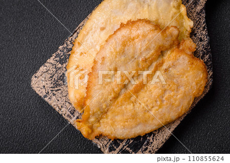 Delicious battered chicken breast chops with salt, spices and herbs 110855624