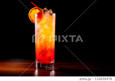 Tequila Sunrise cocktail blend of tequila, orange juice, and grenadine on black Tequila Sunrise cocktail blend of tequila, orange juice, and grenadine on black 110856476