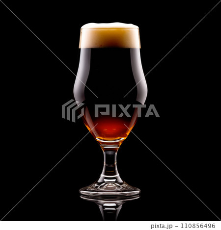 Beer in a tall glass on a dark black background. Mugs with drink like Ipa, Pale Ale, Pilsner, Porter or Stout Beer in a tall glass on a dark black background. Mugs with drink like Ipa, Pale Ale, Pilsner, Porter or Stout 110856496