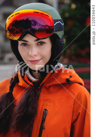 Portrait of a woman in the Alps. Young beautiful caucasian woman in ski goggles looking at the camera with a sexy look 110856643