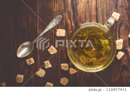 Cup of herbal tea with brown tea sugar 110857411
