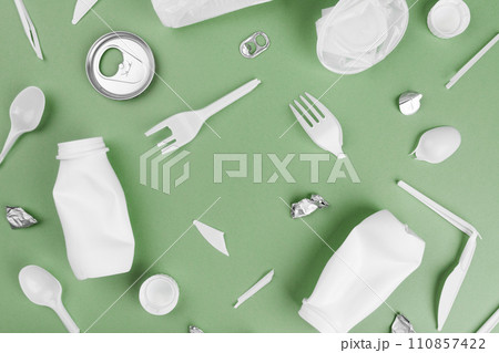 Various recyclable garbage on a green background 110857422