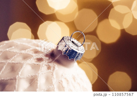 Christmas ball close-up against a background of sparkling garlands 110857567