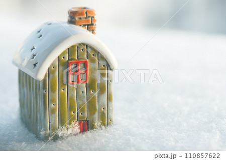 Toy house on snow, natural abstract background. winter season concept. 110857622