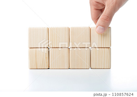 Hand putting and stacking blank wooden cubes on table with copy space for input wording or infographic icon 110857624