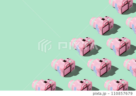 Pattern with SLR camera on pastel color background 110857679