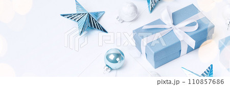 Christmas blue gifts with decorations on white background Christmas blue gifts with decorations on white background 110857686