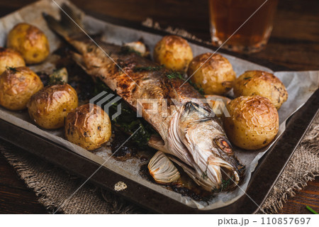 Fish Baked with Sorrel and New Potatoes Fish Baked with Sorrel and New Potatoes 110857697