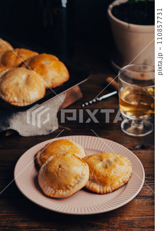 Freshly Baked Pastries Filled with Green Onion and Mushrooms on Plate Freshly Baked Pastries Filled with Green Onion and Mushrooms on Plate 110857731