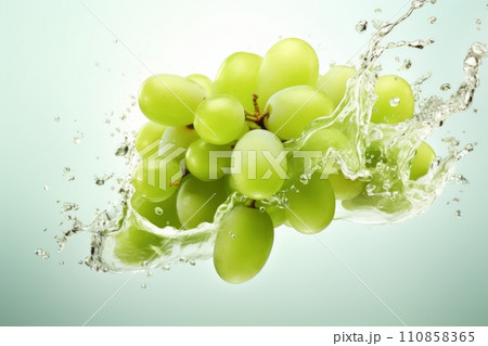 Green grapes in a splash of water and grape juice on a white background 110858365