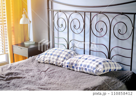 A bed with pillows on it in the room. Interior photography A bed with pillows on it in the room. Interior photography 110858412