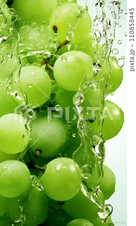 Green grapes in a splash of water and grape juice on a white background 110858445