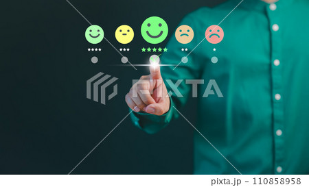 Customer hand touch virtual screen on happy smile face icon to give satisfaction in service. Online review concept of assessment testimonial customer service and feedback, Opinion rating very good. 110858958