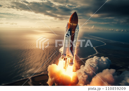 Aerial view of rocket launch at sunrise over ocean coast 110859209