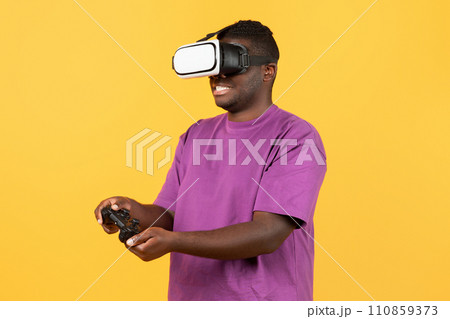African american guy experiencing virtual reality wearing VR headset, studio African american guy experiencing virtual reality wearing VR headset, studio 110859373