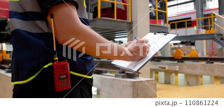 Closeup hands young engineer man or worker checking electric train for planning maintenance. 110861224