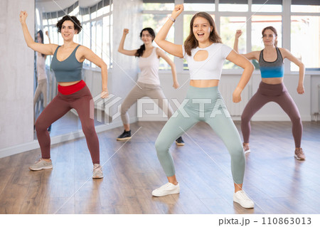 Young female teacher conducts modern hip hop dance lessons for group of girls Young female teacher conducts modern hip hop dance lessons for group of girls 110863013