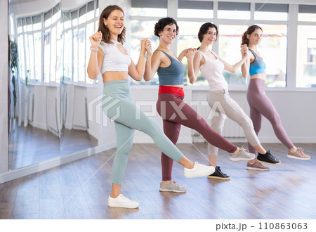 Young girls learn to perform Irish dancing during group classes at fitness center 110863063