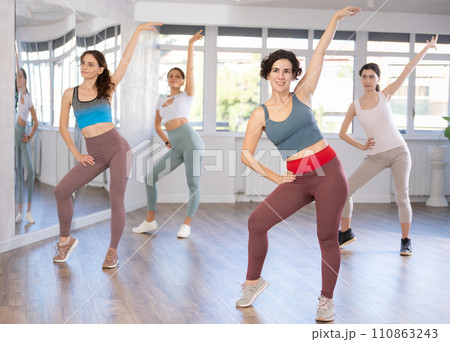 Female teacher conducts modern dance lessons for group of girls 110863243