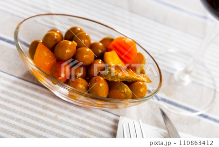 Tasty small serving of olives with carrots pickles and onions 110863412