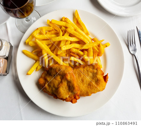 Traditional Spanish dish is goat cheese and pepper booklets with French fries Traditional Spanish dish is goat cheese and pepper booklets with French fries 110863491
