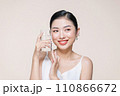 Woman with glass of fresh water in white portrait. 110866672