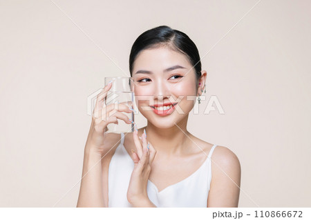 Woman with glass of fresh water in white portrait. 110866672