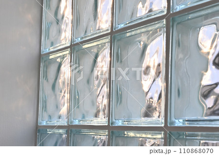 close up glass block wall with golden natural light background, interior design close up glass block wall with golden natural light background, interior design 110868070