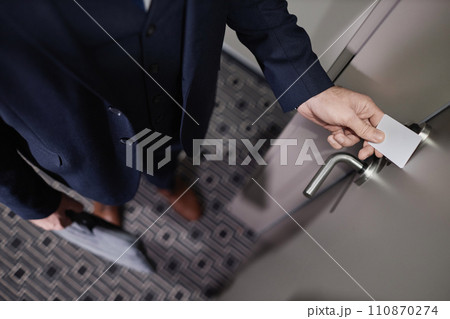 Top view closeup of businessman opening hotel room door with contactless key card, copy space Top view closeup of businessman opening hotel room door with contactless key card, copy space 110870274