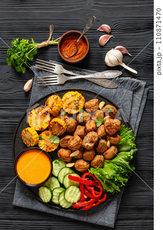 baked meatballs with vegetables and sauce on plate baked meatballs with vegetables and sauce on plate 110871470