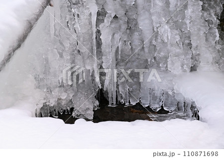 Frozen stream. Beautiful winter nature background. Frost, ice and snow in the winter. Frozen stream. Beautiful winter nature background. Frost, ice and snow in the winter. 110871698
