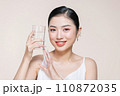Woman with glass of fresh water in white portrait. 110872035