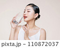 beautiful girl drinking water from transparent glass isolated on white 110872037